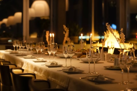 Elegant candlelit dinner table with fine wine